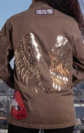 Load image into Gallery viewer, Female models back of CdJ Angel jacket with shiny gold wing appliques.
