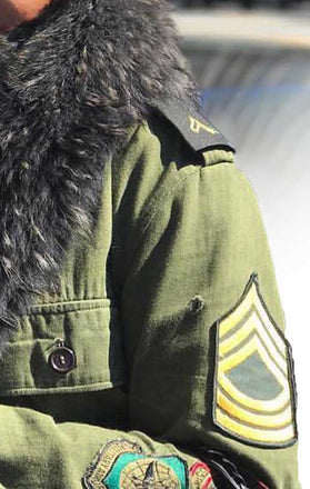 Load image into Gallery viewer, Armband of CdJ Furfly jacket with military-style embellishments and fur collar.
