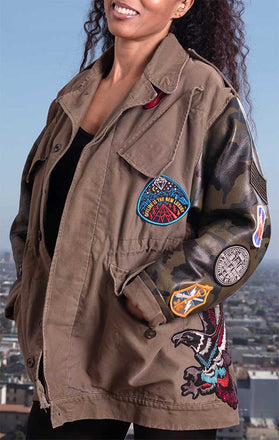 Load image into Gallery viewer, Female models front of CdJ Hides jacket in solid vest and leather camo sleeves with patch embellishments.
