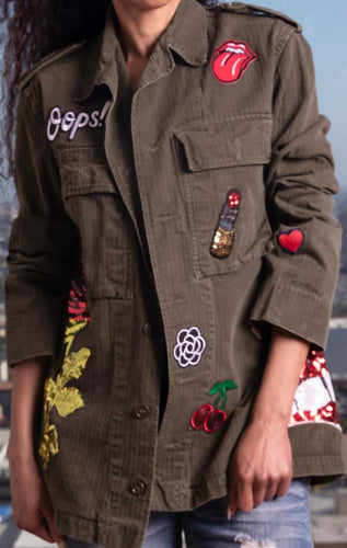 Female models CdJ Drab jacket front view with femme patch embellishments.